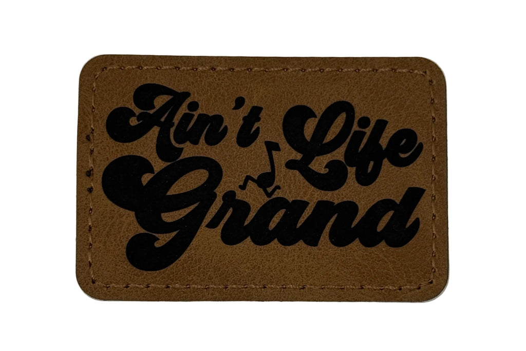 Ain't Life Grand Patch 3x2 | Laser Engraved | Rawhide/Black | Iron or stitch | Panic Fan Art