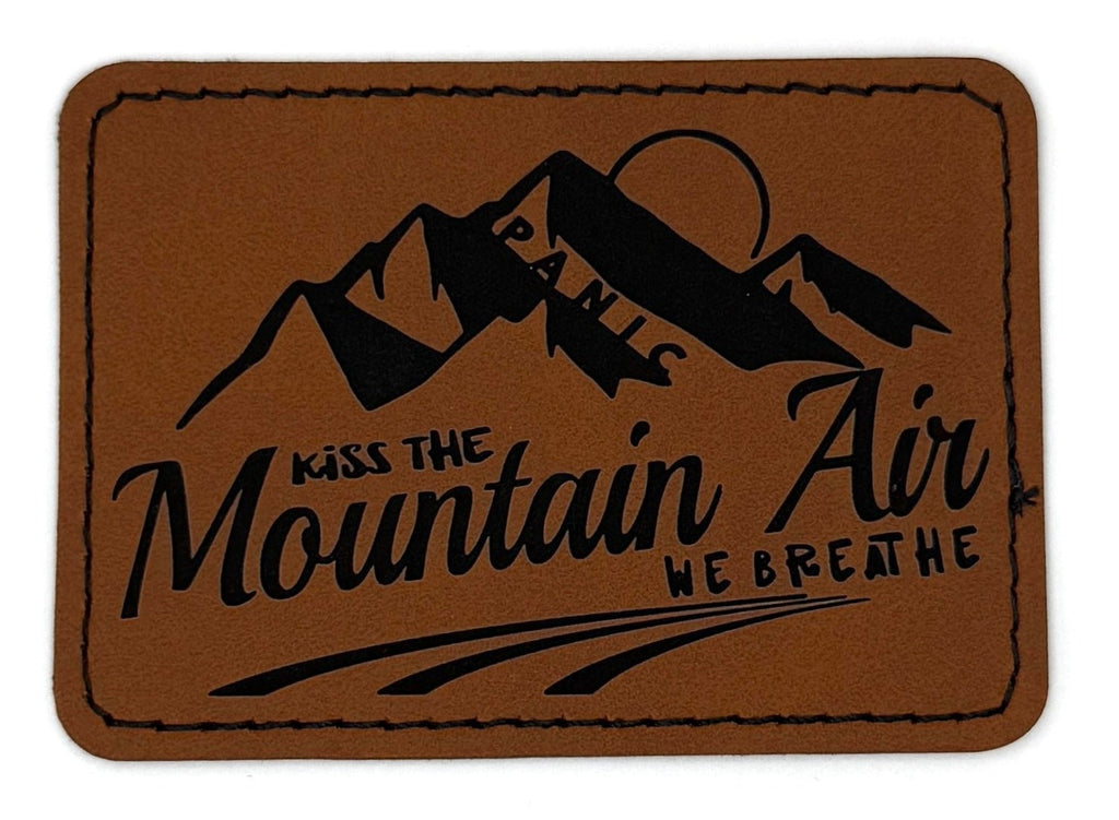 Kiss The Mountain Air Patch 3.5” x 2.5” | Laser Engraved | Rawhide/Black | Iron or stitch | Panic Fan Art