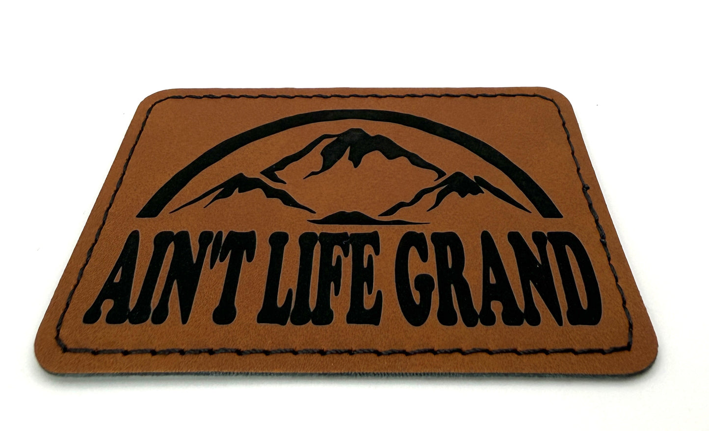 Aint Life Grand Patch 3.5” x 2.5” | Laser Engraved | Rawhide/Black | Iron or stitch | Panic Fan Art